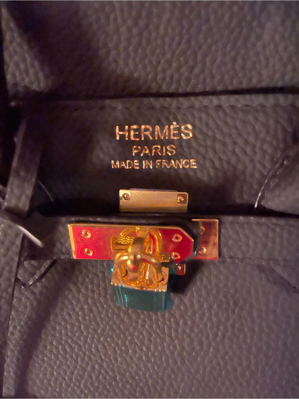 Black Leather Bag with Gold Hardware and Colorful Enamel Lock